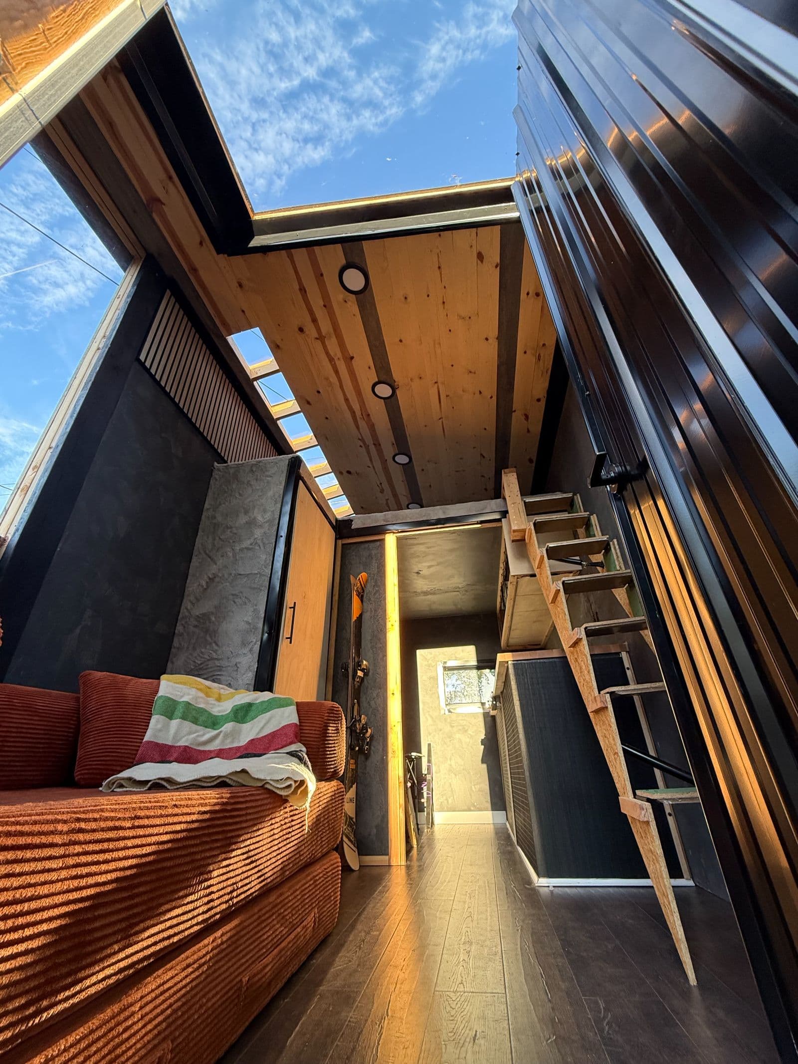Cozy & Efficient 128 Sq Ft Custom Tiny Home/Ski Chalet with Loft Looking for a simple, efficient space or a perfect weekend getaway? This custom 128 sq ft tiny house maximizes every inch of space without feeling cramped. Key Features: Main Living Area: Features a comfortable sofa setup, ideal for relaxing, working, or hosting a guest. Kitchenette: Equipped with a built-in sink and cooktop, giving you everything you need to prep easy meals on the go. Sleeping Loft: An additional 64 sq ft loft space overhead—fits a full or queen mattress comfortably, keeping your main floor open and spacious. Please note that the tiny home does not feature a built-in bathroom—this was intentional to maximize open living space and keep maintenance simple. However, it's very easy to add a self-contained composting toilet (such as a Nature's Head or dry flush system) or a portable camping toilet depending on your setup and needs." - Image 2