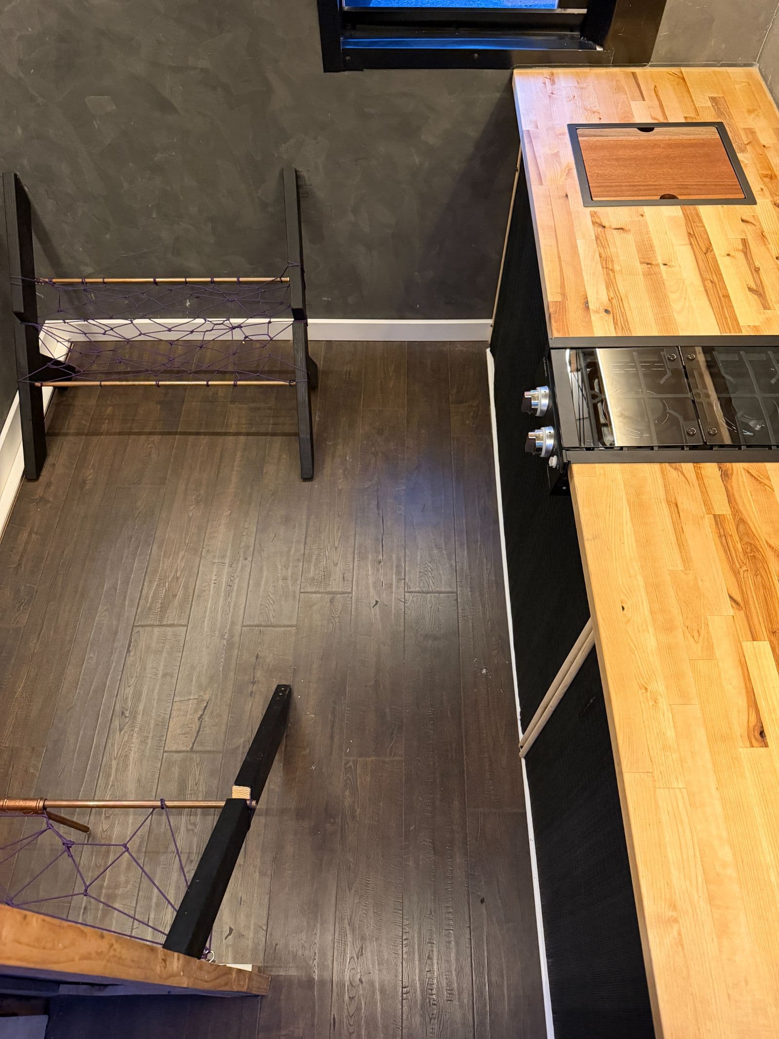 Cozy & Efficient 128 Sq Ft Custom Tiny Home/Ski Chalet with Loft Looking for a simple, efficient space or a perfect weekend getaway? This custom 128 sq ft tiny house maximizes every inch of space without feeling cramped. Key Features: Main Living Area: Features a comfortable sofa setup, ideal for relaxing, working, or hosting a guest. Kitchenette: Equipped with a built-in sink and cooktop, giving you everything you need to prep easy meals on the go. Sleeping Loft: An additional 64 sq ft loft space overhead—fits a full or queen mattress comfortably, keeping your main floor open and spacious. Please note that the tiny home does not feature a built-in bathroom—this was intentional to maximize open living space and keep maintenance simple. However, it's very easy to add a self-contained composting toilet (such as a Nature's Head or dry flush system) or a portable camping toilet depending on your setup and needs." - Image 5